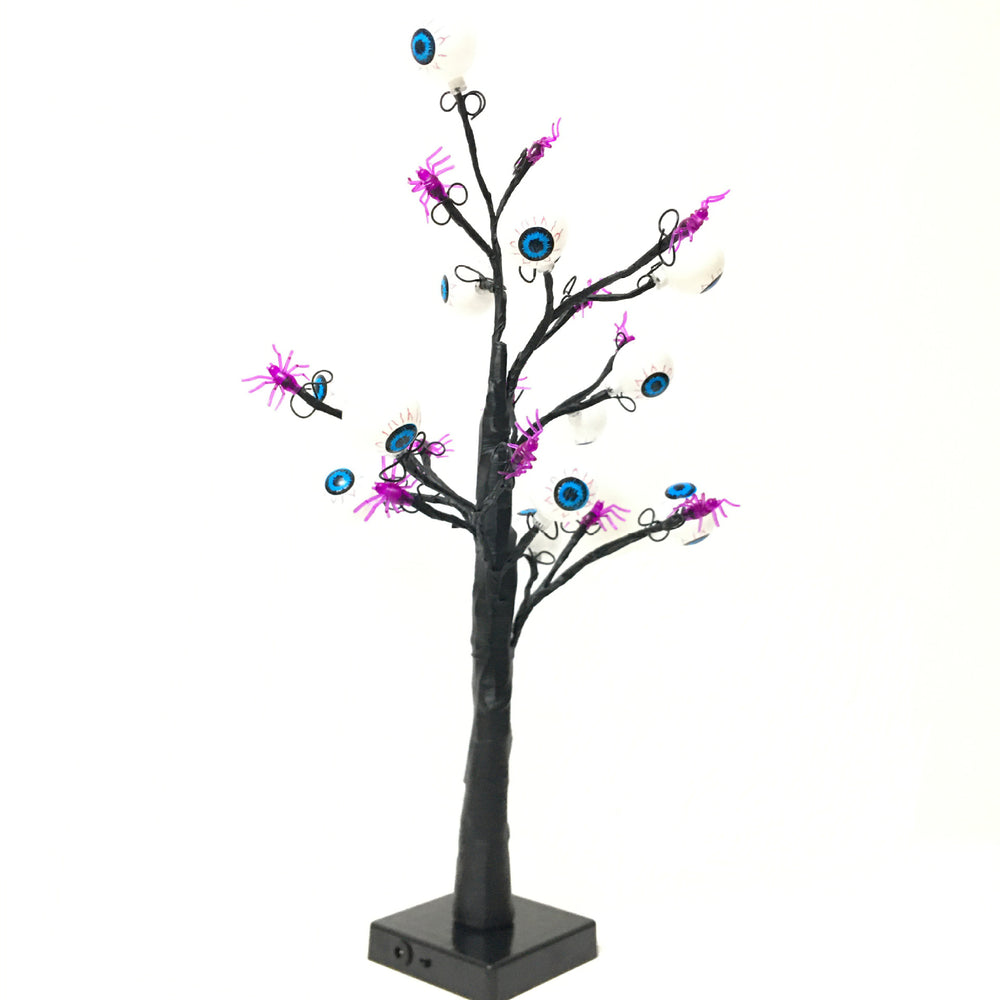 Schaurige Augenbaum-Lampe ausgeschaltet vor weißem Hintergrund mit schwarzem Stamm und Sockel