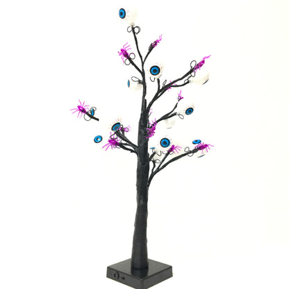 Schaurige Augenbaum-Lampe ausgeschaltet vor weißem Hintergrund mit schwarzem Stamm und Sockel